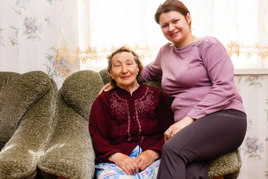Grandmother and adult granddaughter embraced and happy