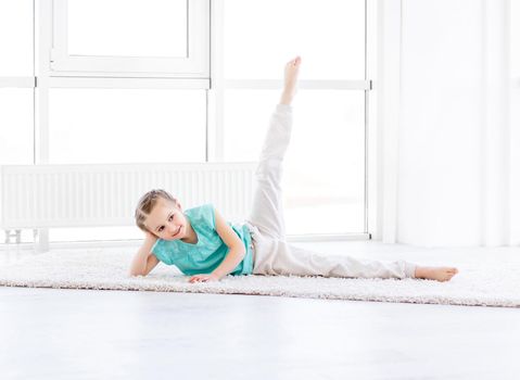 Cute little girl doing workout in gym