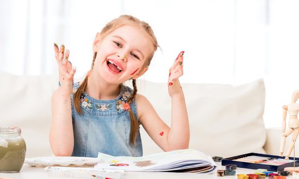 Artistic girl is showing her messed painted palms