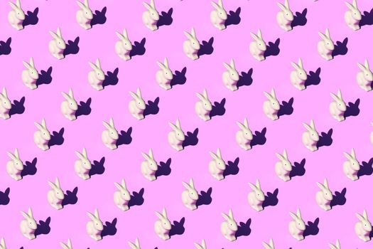 Pattern composition of Easter bunnies on pastel red background. Minimalist isometric concept.