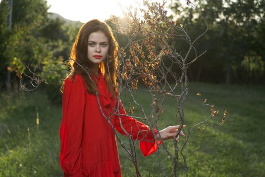 attractive woman in red dress outdoors fresh air summer. High quality photo