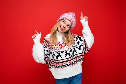 Photo of young positive happy smiling beautiful woman with sincere emotions wearing stylish clothes isolated over background with copy space and dancing.