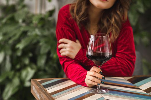 Female image with a glass of wine in hands