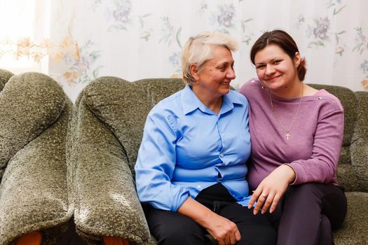 pretty woman and senior mother at home