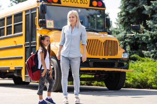 Mother taking her daughter to school, saying her goodbye for the day