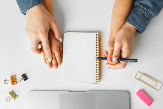 Mother and child hands writing in a notepad, top view, copy space