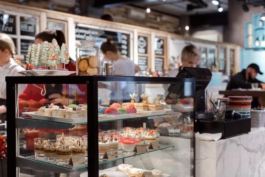 Showcase of sweets in a cafeBeautiful showcase with a large assortment of sweet in a cafe