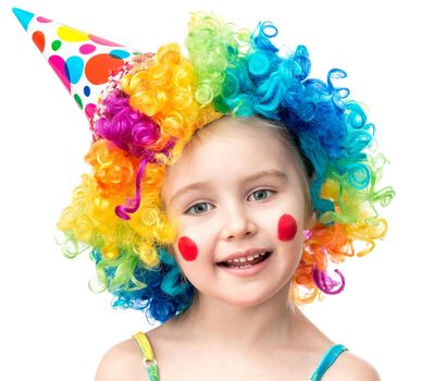 Portrait of little girl in colourful clown wig and birthday hat isolated on a white background