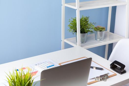 paperwork in the office and laptop on the desktop