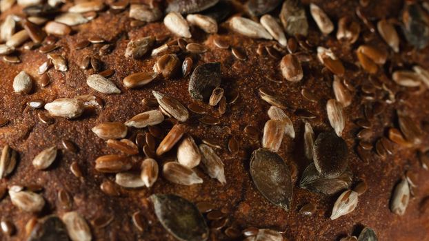 Close-up surface of homemade whole grain bread, food background, texture.
