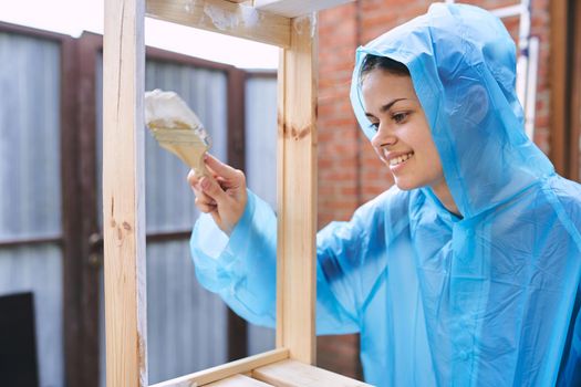 women paint wooden structures brush painter decoration. High quality photo