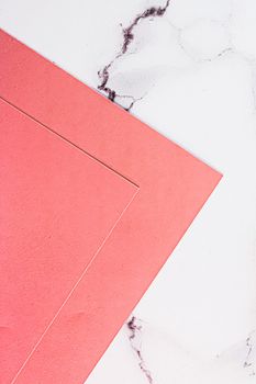 Pink A4 papers on white marble background as office stationery flatlay, luxury branding flat lay and brand identity design for mockups