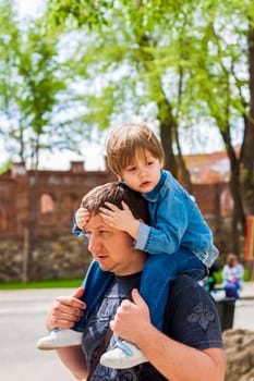 A male father spends time with his young son. Family walks in nature. The joy of being together.