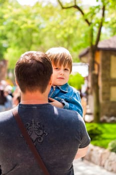 A male father spends time with his young son. Family walks in nature. The joy of being together.