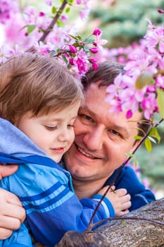 A male father spends time with his young son. Family walks in nature. The joy of being together.