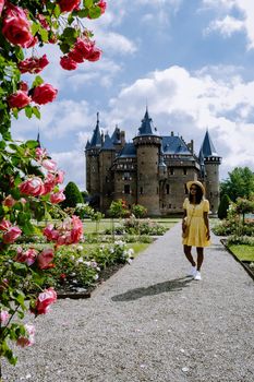 Castle de Haar Utrecht, couple men and woman mid age Asian visit De Haar Castle in Dutch Kasteel de Haar is located in Utrecht Netherlands during Spring with flowers in the garden