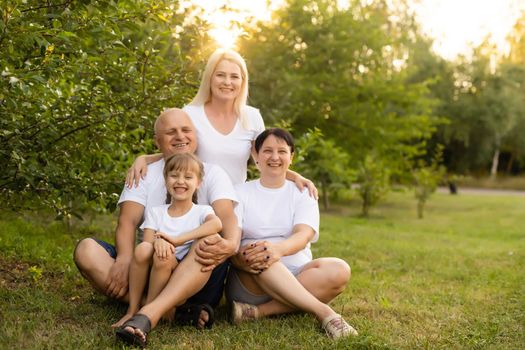 Portrait of cheerful extended family sitting in the park