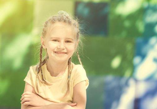 cute little girl smiling in the morning park. blurred background