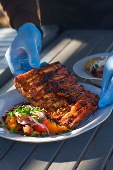 Chef cooked BBQ ribs sliced with hot honey and chili marinade, street food