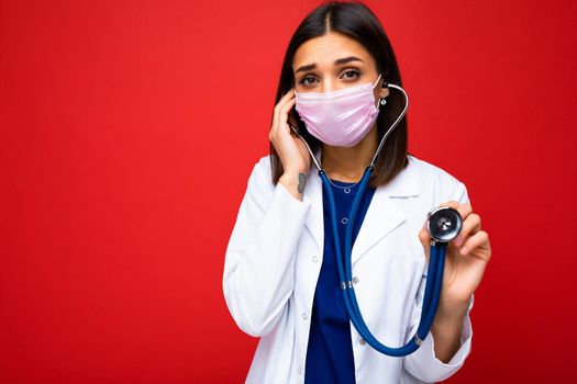 Female Doctor Wearing Medical Mask and Stethoscope isolated on background. Free space