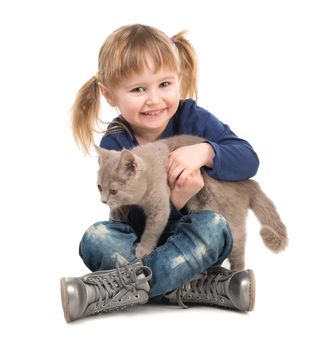 cute little girl sitting on the floor with cat in hands isolated on white background