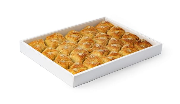 Assortment of Turkish baklava dessert in a white box isolated on white background