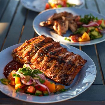 BBQ ribs sliced with hot honey and chili marinade, street food