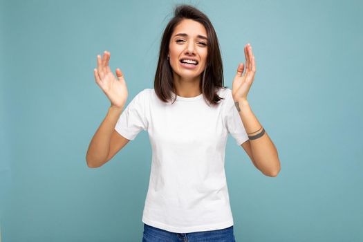 Photo of young positive happy beautiful woman with sincere emotions wearing stylish clothes isolated over background with copy space and saying something.