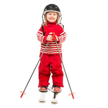 little girl in red ski suit standing on skis with ski poles and in helmet isolated on white background