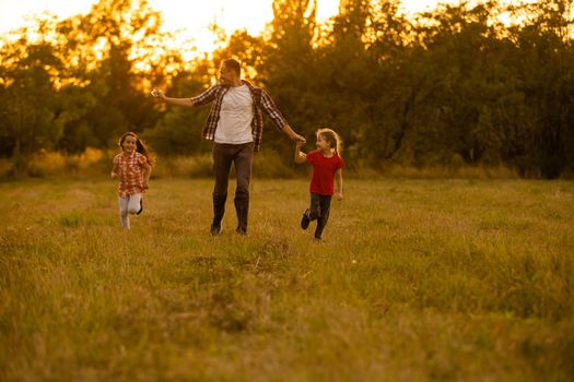 Dad with his little daughter let a kite in a field