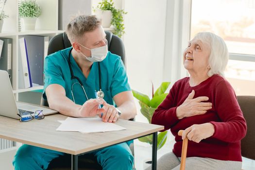 Elderly woman complaining to doctor about health during appointment in clinic