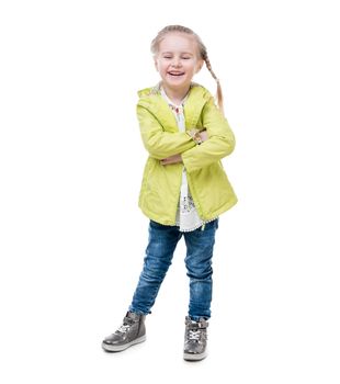 Little girl in a yellow jacket, silvery shirt standing, hugging herself, isolated on white background