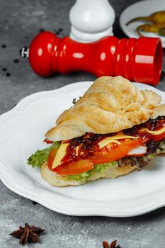 Delicious ham and cheddar cheese croissant with salad.