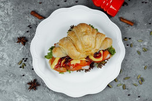 Delicious ham and cheddar cheese croissant with salad.