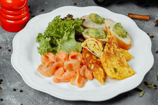 omelet with red fish and vegetables, beautiful serving.