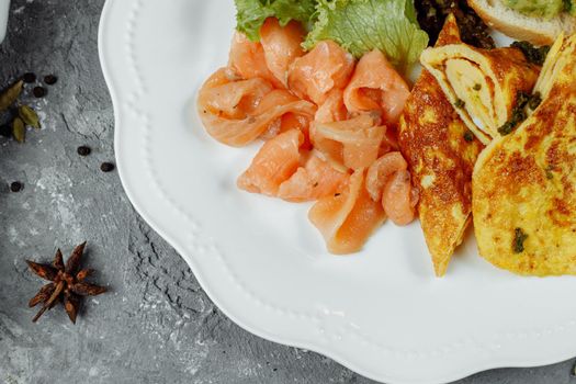omelet with red fish and vegetables, beautiful serving.