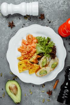 omelet with red fish and vegetables, beautiful serving.