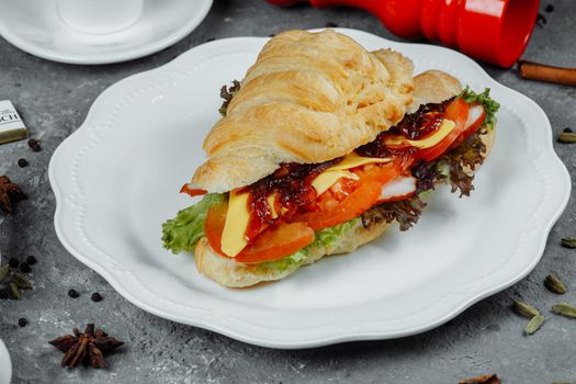 Delicious ham and cheddar cheese croissant with salad.