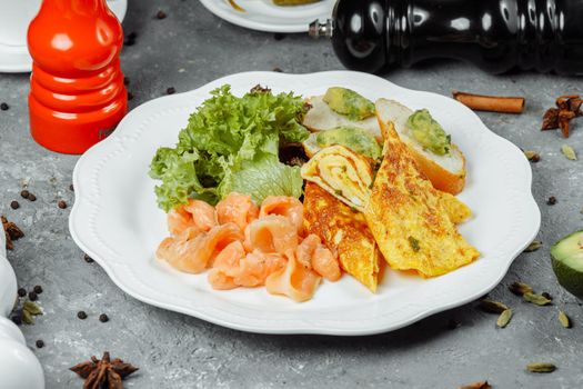 omelet with red fish and vegetables, beautiful serving.