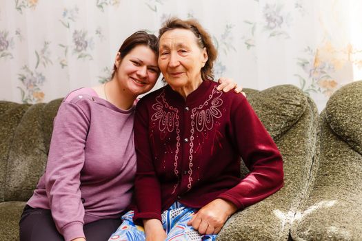 Grandmother and adult granddaughter embraced and happy