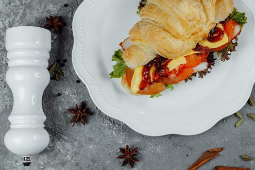 Delicious ham and cheddar cheese croissant with salad.