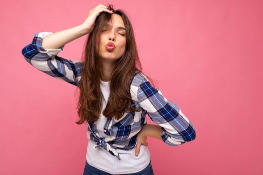 Photo shot of cute nice charming gorgeous attractive pretty youngster happy woman wearing stylish clothes isolated over colorful background with copy space and giving kiss.