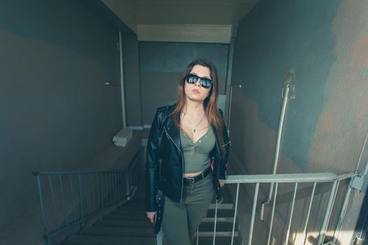 Women independence and feminism concept - Girl on dark stairs in military style