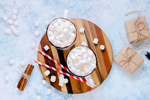 Christmas Hot Drink. White Cups of Cocoa or Chocolate with Marshmallows and Spices Cinnamon on Light Background with Christmas Decorations. Flat Lay.