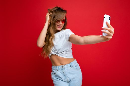 Close-up portrait nice-looking charming attractive lovely cheery lady making taking selfie isolated over bright vivid shine red background.