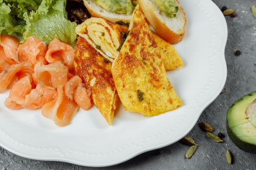 omelet with red fish and vegetables, beautiful serving.
