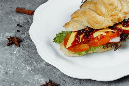 Delicious ham and cheddar cheese croissant with salad.