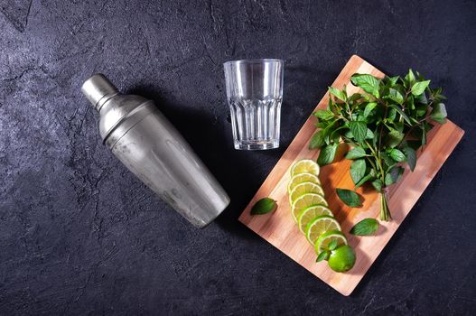 Mojito Cocktail Making. Mint, Lime,Glass and Bar Shaker on Dark Stone Table. Copy Space For Your Text.