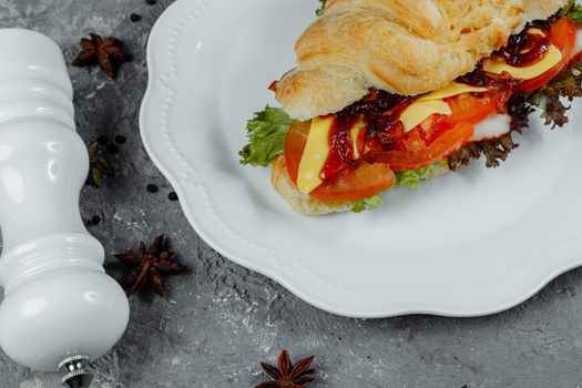 Delicious ham and cheddar cheese croissant with salad.