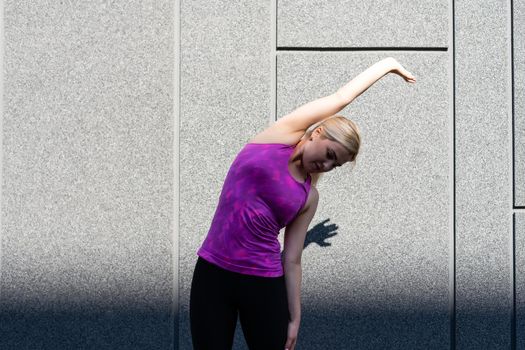 Sport woman doing stretching exercise during outdoor cross training workout